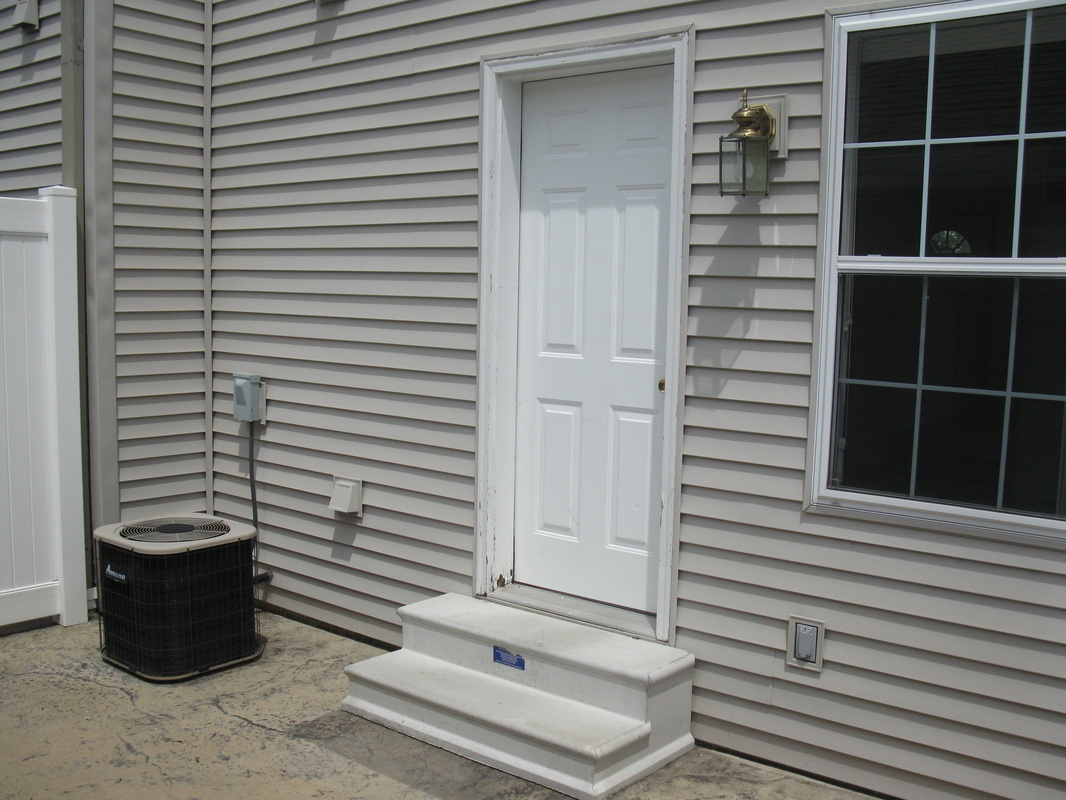 Back patio door from the outside of 300 Place Town home