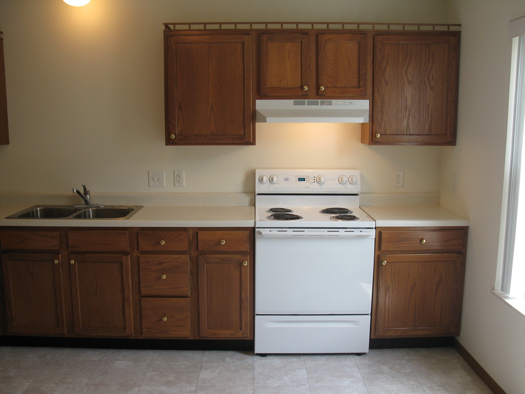 Kitchen stove and sink in 300 Place Town Home