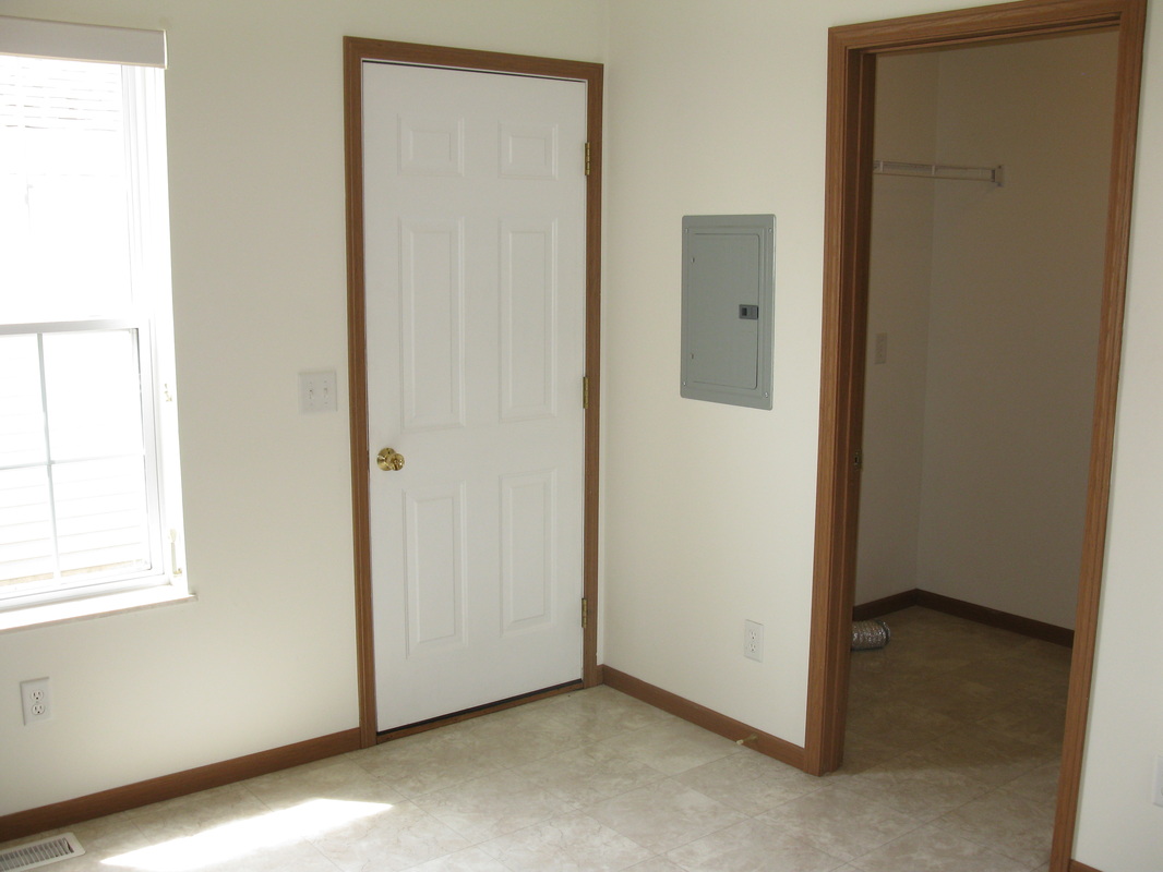 In the kitchen, looking at the back door to Private patio on the left and laundry room on the right in 300 Place Town Home