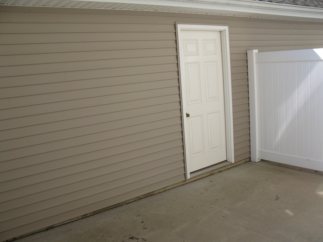 Door to garage from patio outside 400 Place Town home