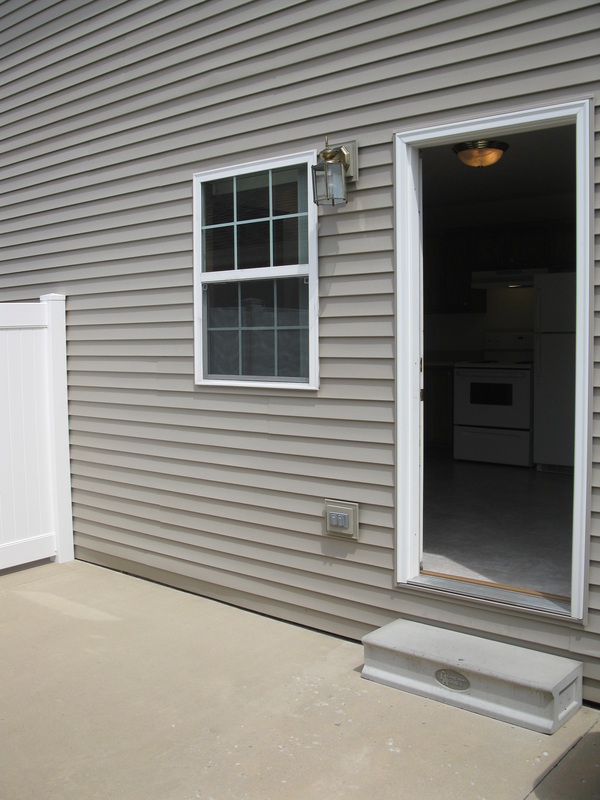 Private patio looking back towards door to kitchen in 500 Place 2 bedroom town home