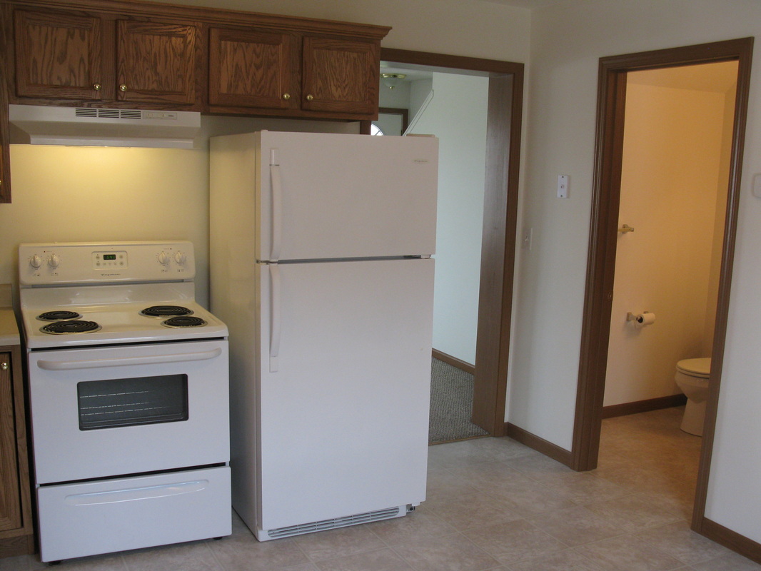 Kitchen with living room on the left and half bathroom on the right in 500 Place 2 bedroom town home