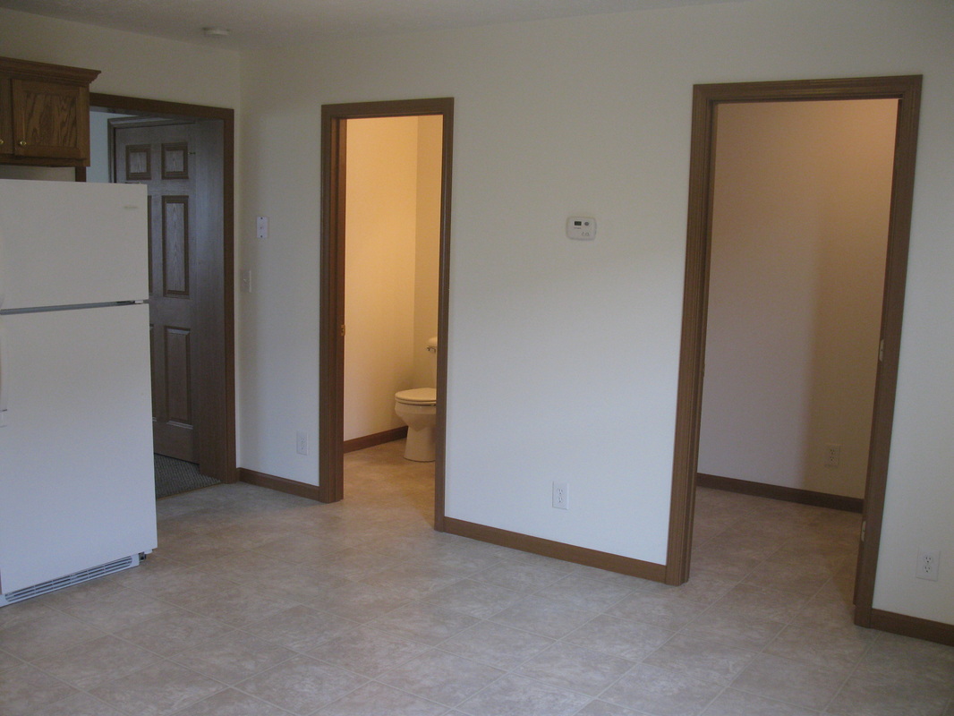 Kitchen view with half bathroom to the left and laundry room to the right in 500 Place 3 bedroom town home