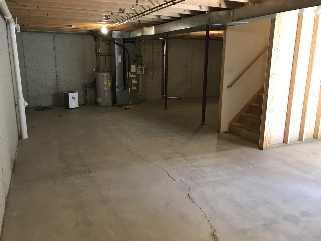 Unfinished basement with water heater and furnace in Parkview B Duplex